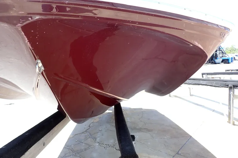 Slide: The Image of 2021 Hurricane SunDeck Sport 185 OB boat hull in maroon, displayed on a trailer. - 67
