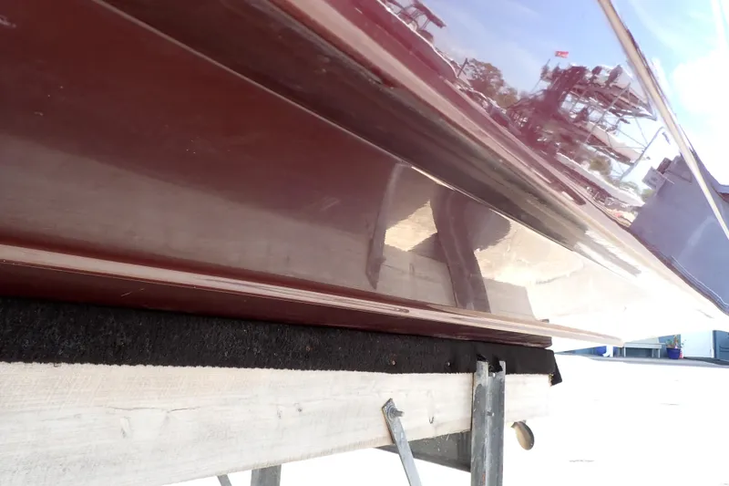 Slide: The Image of 2021 Hurricane SunDeck Sport 185 OB boat hull on trailer, reflecting surroundings. - 69