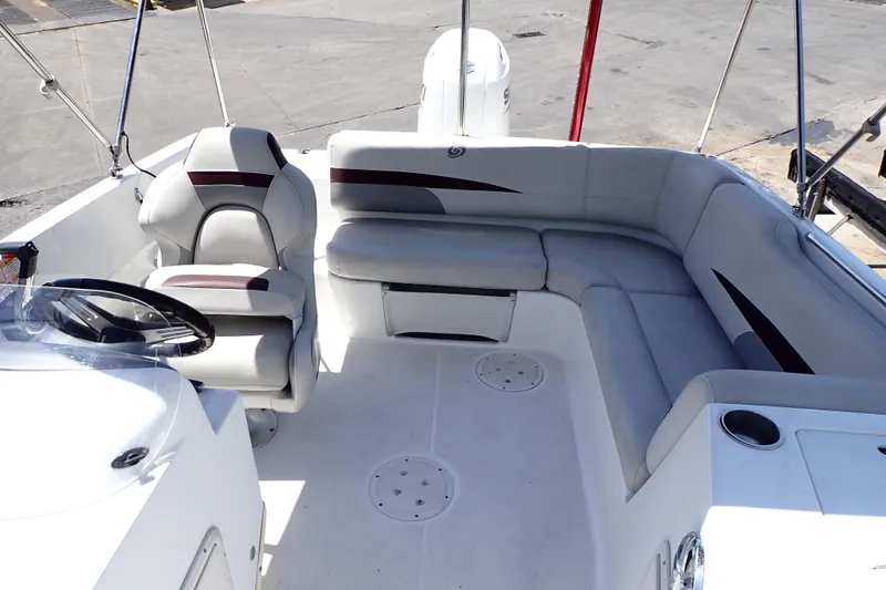 Slide: The Image of 2021 Hurricane SunDeck Sport 185 OB boat interior with seating and steering wheel. - 8