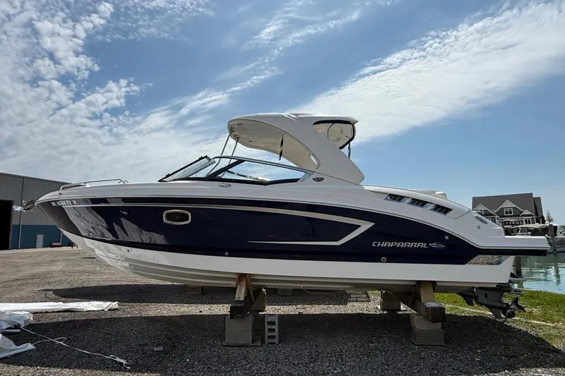 The Image of 2016 Chaparral 307 SSX boat on dry dock under a partly cloudy sky. - 0