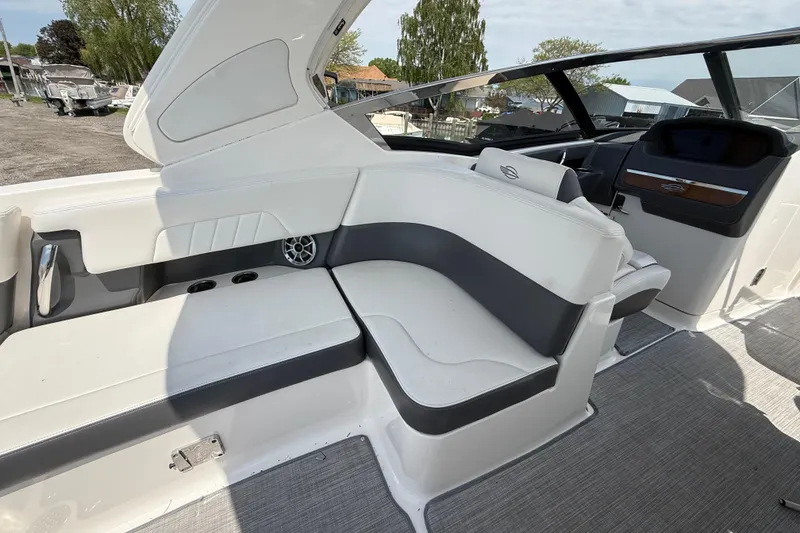 Slide: The Image of 2016 Chaparral 307 SSX boat interior with white seating and modern dashboard. - 11
