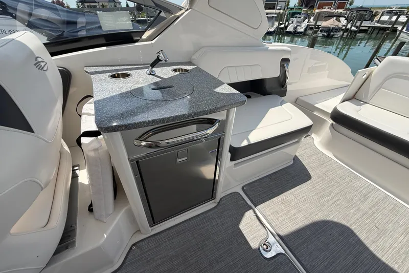 Slide: The Image of 2016 Chaparral 307 SSX boat interior with kitchenette and seating area. - 12