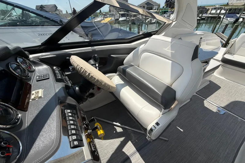 Slide: The Image of 2016 Chaparral 307 SSX boat interior with steering wheel and seating area. - 15