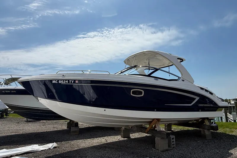 Slide: The Image of 2016 Chaparral 307 SSX boat on display under a clear blue sky. - 2