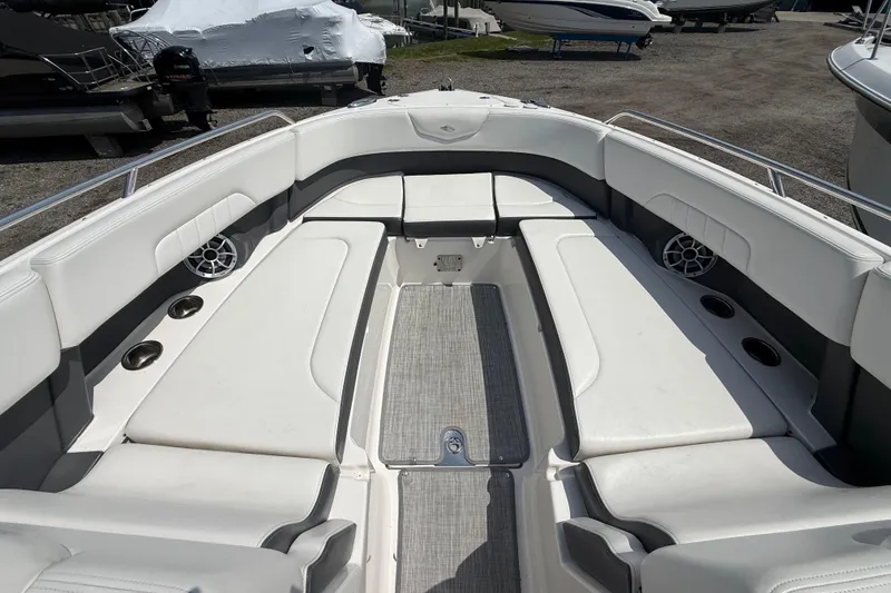 Slide: The Image of 2016 Chaparral 307 SSX boat interior with white seating and cup holders. - 22
