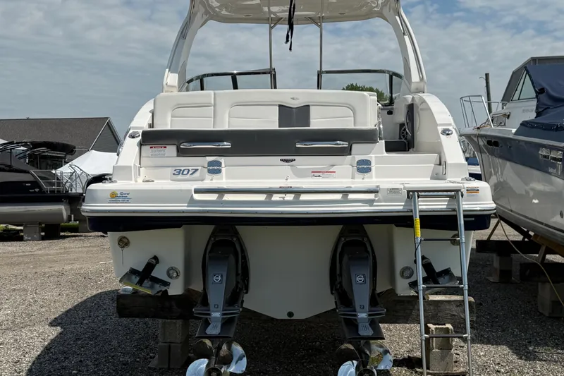 Slide: The Image of 2016 Chaparral 307 SSX boat rear view with dual engines and swim platform. - 5