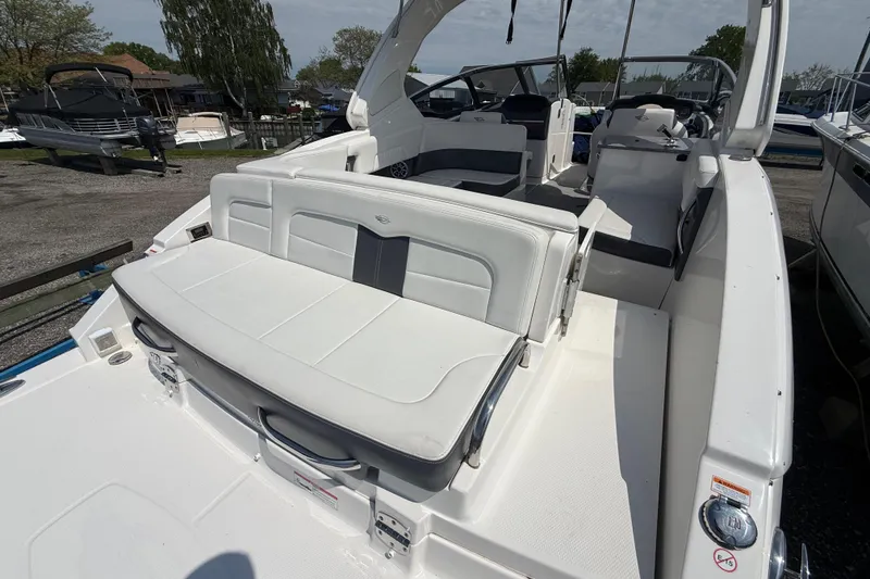Slide: The Image of 2016 Chaparral 307 SSX boat interior with white seating and open cockpit design. - 8