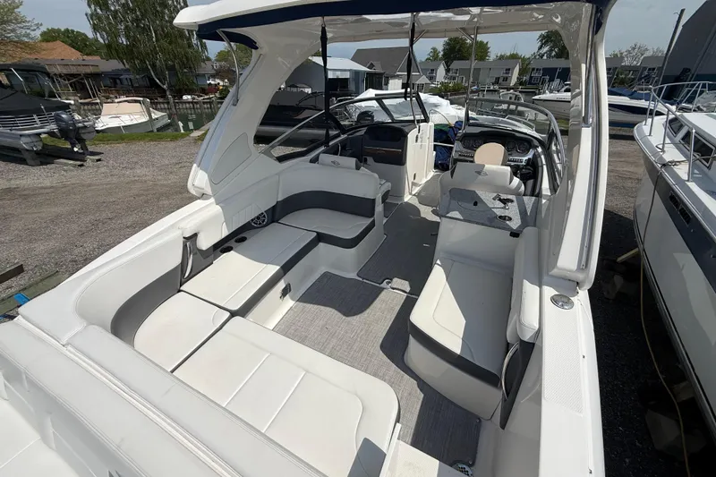 Slide: The Image of 2016 Chaparral 307 SSX boat interior with spacious seating and modern dashboard. - 9