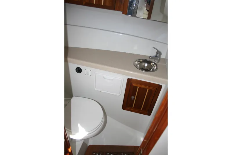 Slide: The Image of Compact bathroom in 2014 Ocean Sport 27' Legacy boat with sink and toilet. - 12