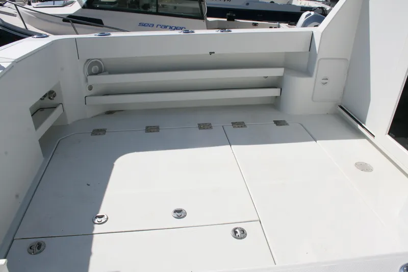 Slide: The Image of 2014 Ocean Sport 27' Legacy boat deck with storage compartments and seating area. - 18