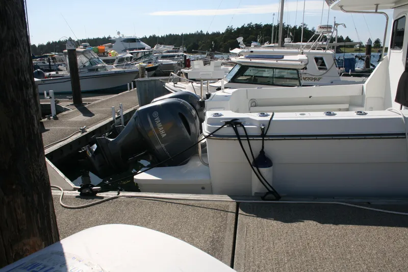 Slide: The Image of 2014 Ocean Sport 27' Legacy boat docked with Yamaha outboard motor. - 21