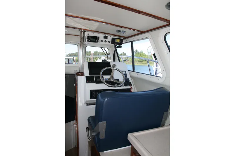 Slide: The Image of Interior view of 2014 Ocean Sport 27' Legacy boat cockpit with steering wheel. - 4
