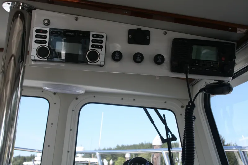 Slide: The Image of Interior electronics of a 2014 Ocean Sport 27' Legacy boat, featuring radio and control panel. - 6