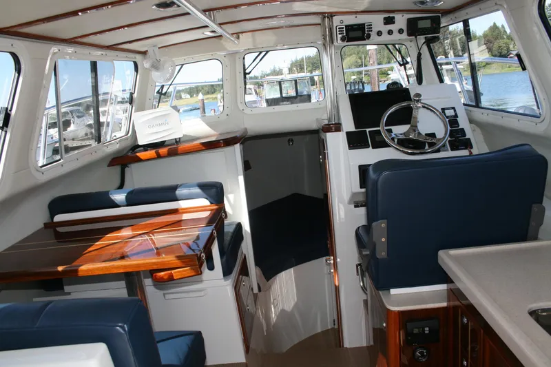 Slide: The Image of Interior of a 2014 Ocean Sport 27' Legacy boat with seating and navigation equipment. - 8