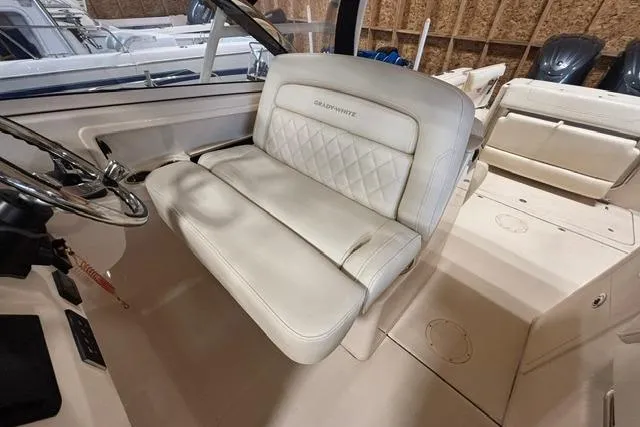 Slide: The Image of 2022 Grady-White Freedom 285 boat interior with luxurious seating and steering wheel. - 10