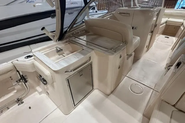 Slide: The Image of 2022 Grady-White Freedom 285 boat interior with sink and seating area. - 15