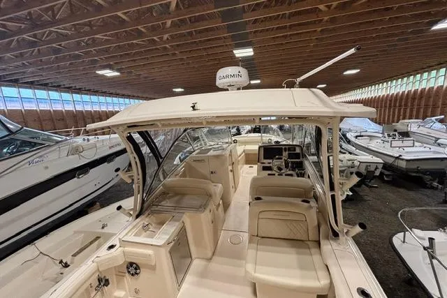 Slide: The Image of 2022 Grady-White Freedom 285 boat in indoor storage, featuring Garmin equipment. - 17
