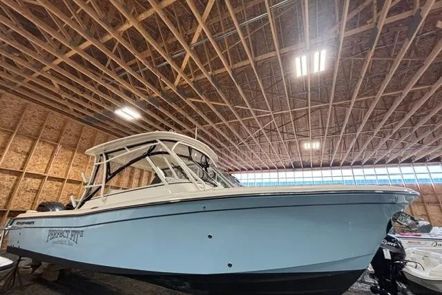 Slide: The Image of 2022 Grady-White Freedom 285 boat in a wooden storage facility. - 2