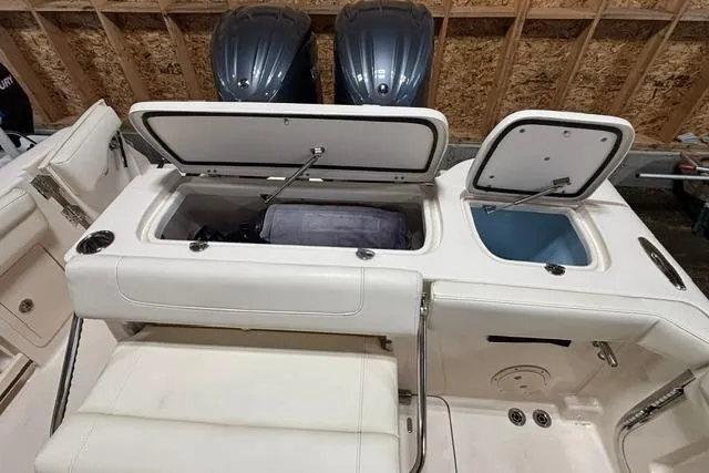 Slide: The Image of 2022 Grady-White Freedom 285 boat interior with open storage compartments and dual engines. - 20