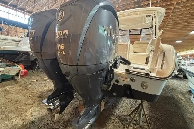 Slide: The Image of 2022 Grady-White Freedom 285 boat with dual Yamaha V6 outboard engines in a storage facility. - 3