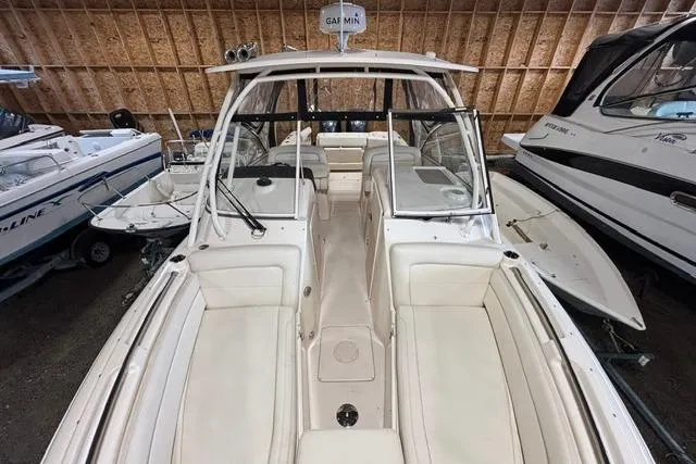 Slide: The Image of 2022 Grady-White Freedom 285 boat in showroom, featuring spacious seating and modern design. - 7