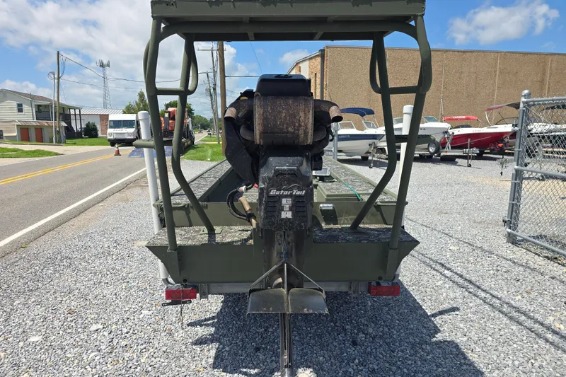 Slide: The Image of Rear view of a 2015 Gator Tail 1854 boat on a gravel lot. - 2