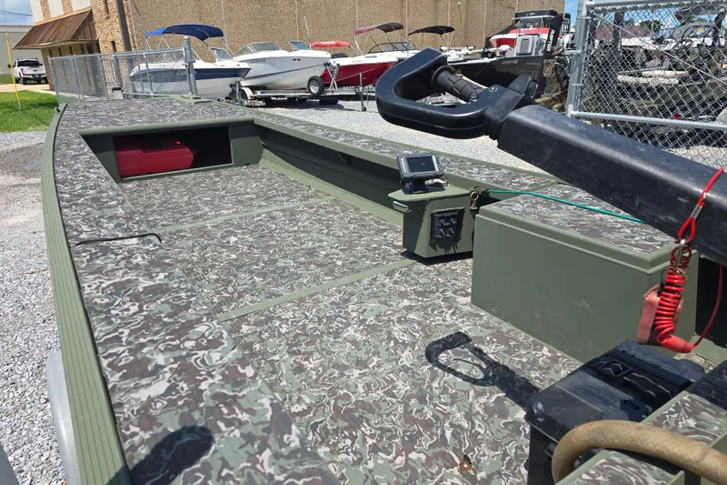 Slide: The Image of 2015 Gator Tail 1854 boat with camouflage deck, parked outdoors. - 3