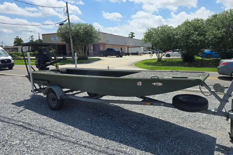 Slide: The Image of 2015 Gator Tail 1854 boat on trailer in parking lot, sunny day. - 6