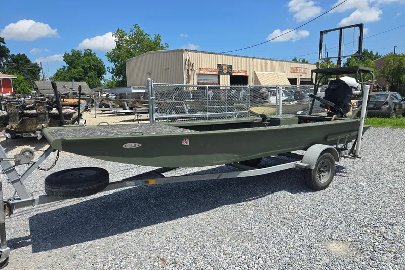 Slide: The Image of 2015 Gator Tail 1854 boat on trailer, parked outdoors under a clear blue sky. - 8