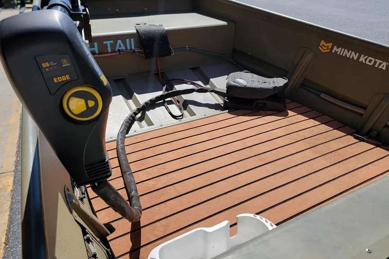 Slide: The Image of 2015 Tracker Topper 1542 LW Riveted Jon boat with Minn Kota motor and wooden deck. - 10