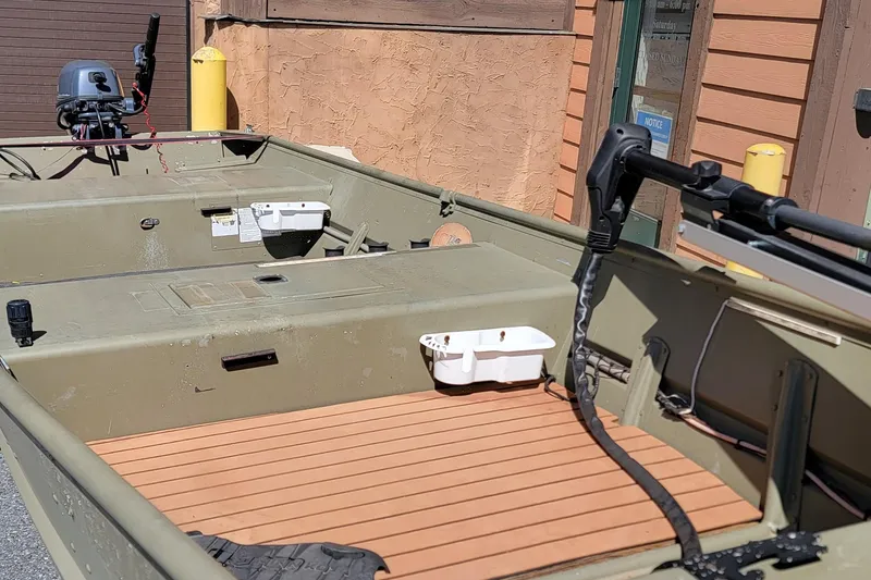 Slide: The Image of 2015 Tracker Topper 1542 LW Riveted Jon boat with motor, docked outdoors. - 4