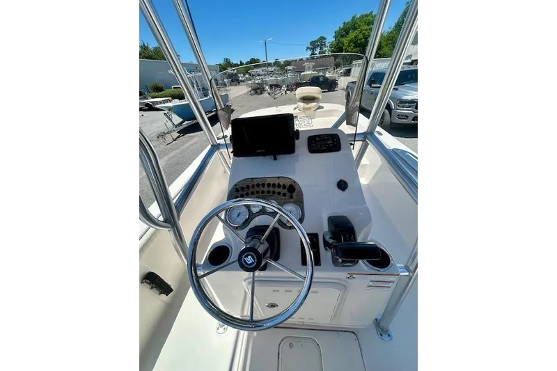 Slide: The Image of 2022 Carolina Skiff 21 LS boat console with steering wheel and controls. - 13