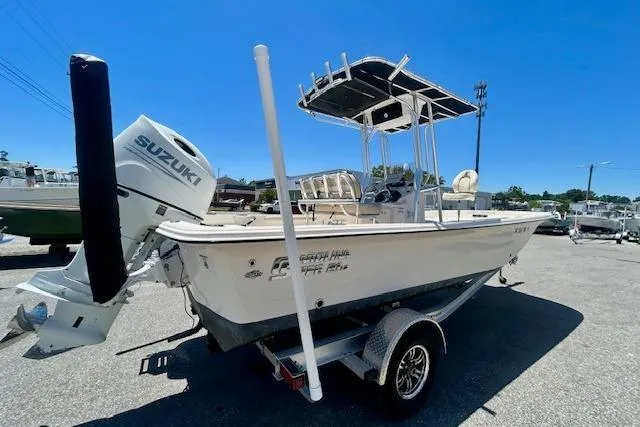 Slide: The Image of 2022 Carolina Skiff 21 LS boat with Suzuki outboard motor on trailer. - 2