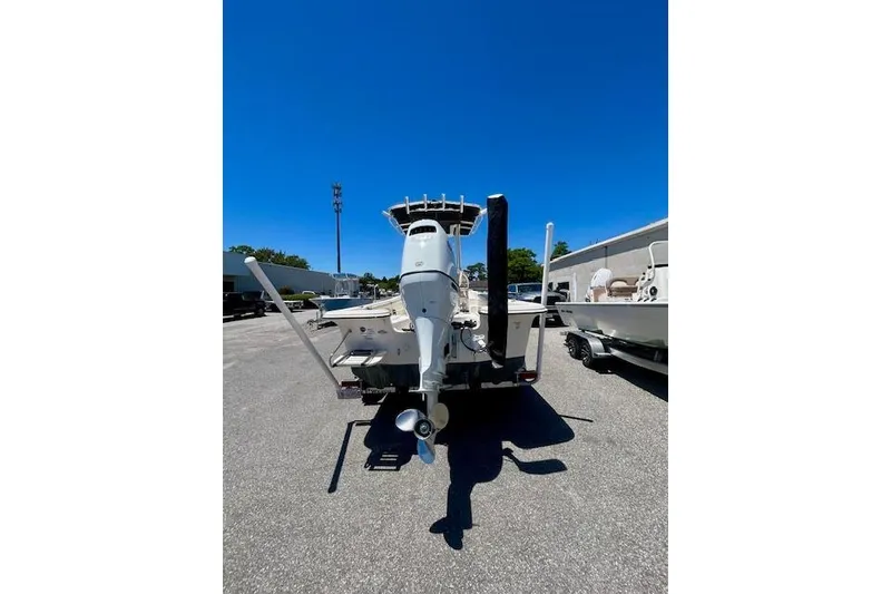 Slide: The Image of 2022 Carolina Skiff 21 LS boat on trailer, rear view under clear blue sky. - 5