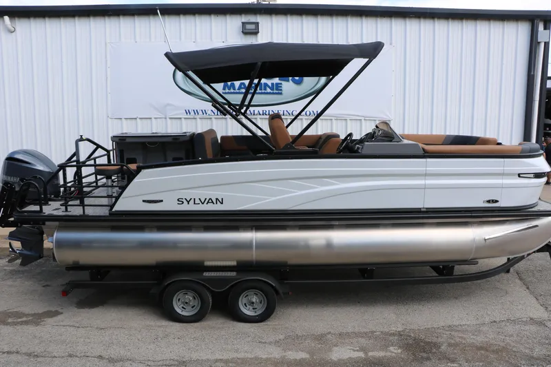 Slide: The Image of 2026 Sylvan L3 DLZ Bar Platinum Edition Tri-Toon boat on trailer, side view. - 17