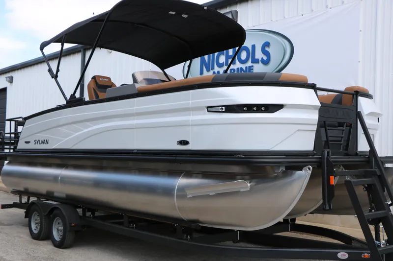 Slide: The Image of 2026 Sylvan L3 DLZ Bar Platinum Edition Tri-Toon boat on trailer at Nichols Marine. - 3