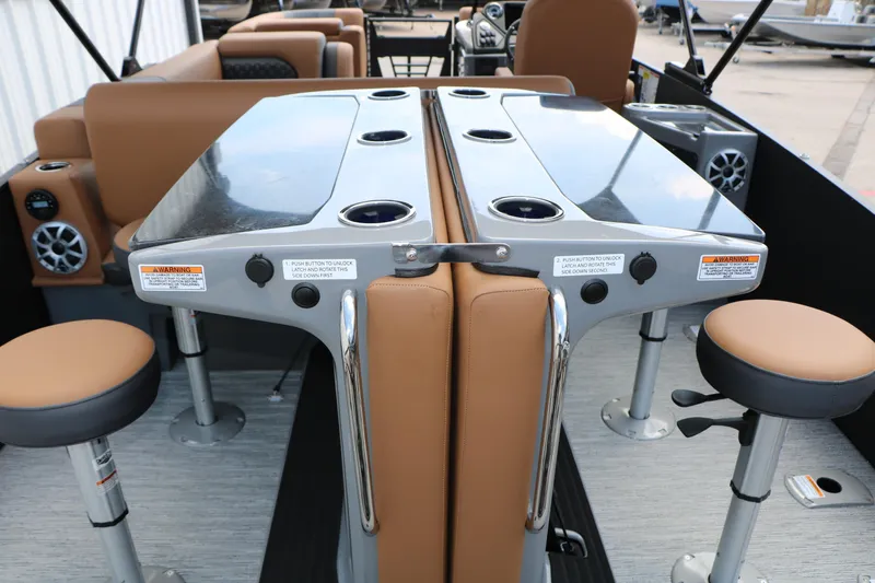 Slide: The Image of 2026 Sylvan L3 DLZ Bar Platinum Edition Tri-Toon interior with bar seating and cup holders. - 33