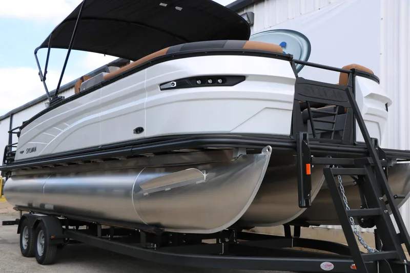 Slide: The Image of 2026 Sylvan L3 DLZ Bar Platinum Edition Tri-Toon on trailer, showcasing sleek design. - 5