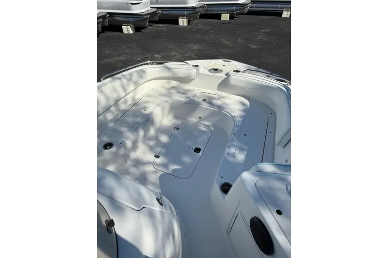 Slide: The Image of 2015 Hurricane SunDeck Sport CC 231 OB boat interior with seating and storage compartments. - 10
