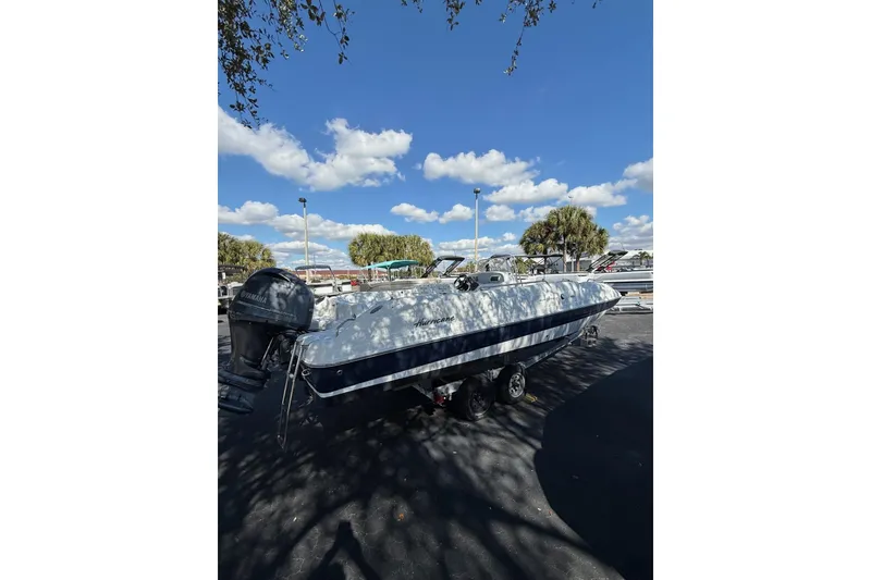 Slide: The Image of 2015 Hurricane SunDeck Sport CC 231 OB boat with Yamaha outboard motor in sunny marina. - 3