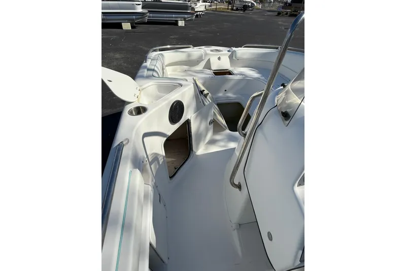 Slide: The Image of 2015 Hurricane SunDeck Sport CC 231 OB boat interior with open storage compartments. - 7