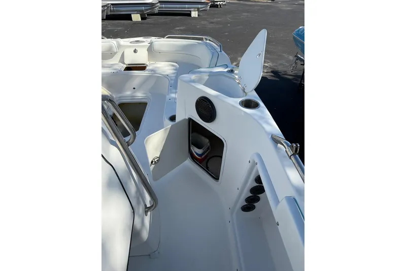 Slide: The Image of 2015 Hurricane SunDeck Sport CC 231 OB boat interior with open storage compartments. - 8