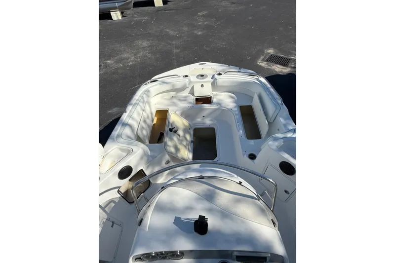 Slide: The Image of 2015 Hurricane SunDeck Sport CC 231 OB boat interior with seating and storage compartments. - 9