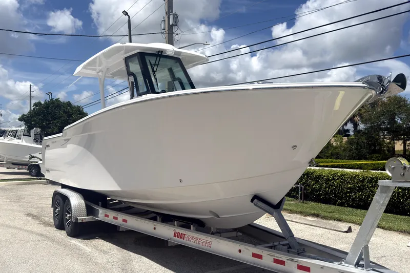 The Image of 2023 Bertram 28 CC boat on trailer under blue sky. - 0