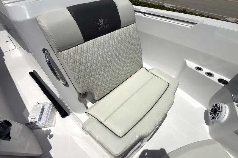 Slide: The Image of 2023 Bertram 28 CC boat seat with quilted upholstery and speaker detail. - 11