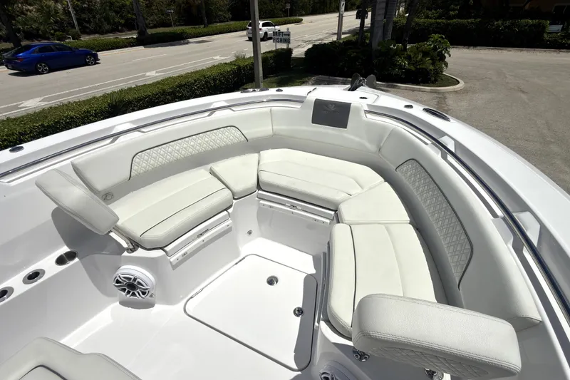 Slide: The Image of Luxurious seating area on 2023 Bertram 28 CC boat, featuring elegant white upholstery. - 12