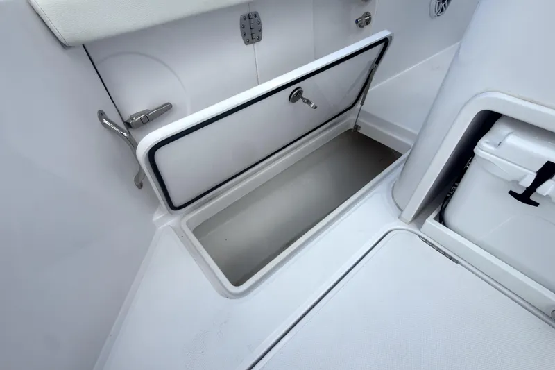 Slide: The Image of 2023 Bertram 28 CC boat storage compartment with open hatch, showcasing interior space. - 15