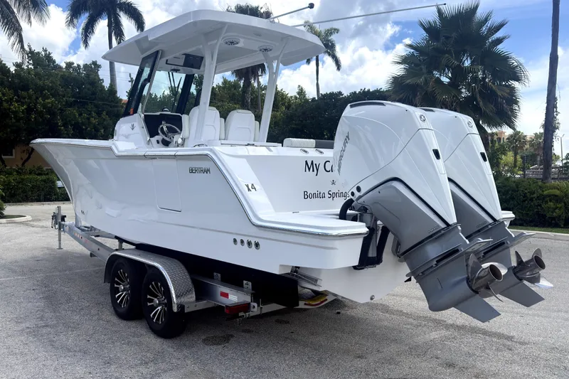 Slide: The Image of 2023 Bertram 28 CC boat on trailer with dual Mercury outboard engines. - 2