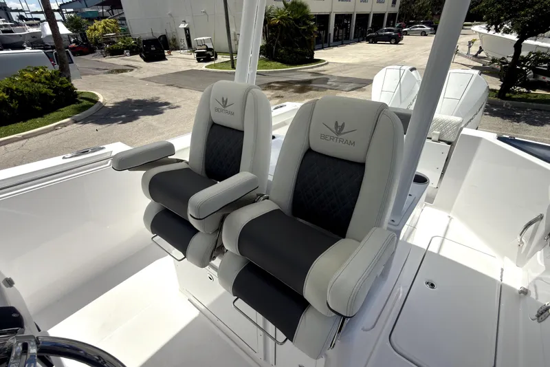 Slide: The Image of 2023 Bertram 28 CC boat seats, luxurious design, outdoor setting. - 22