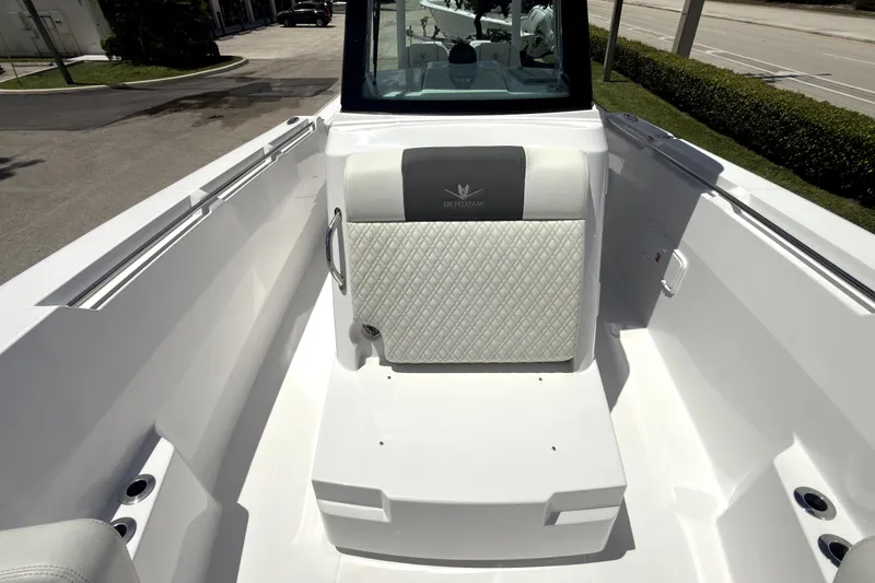Slide: The Image of 2023 Bertram 28 CC boat interior with cushioned seating and sleek design. - 26